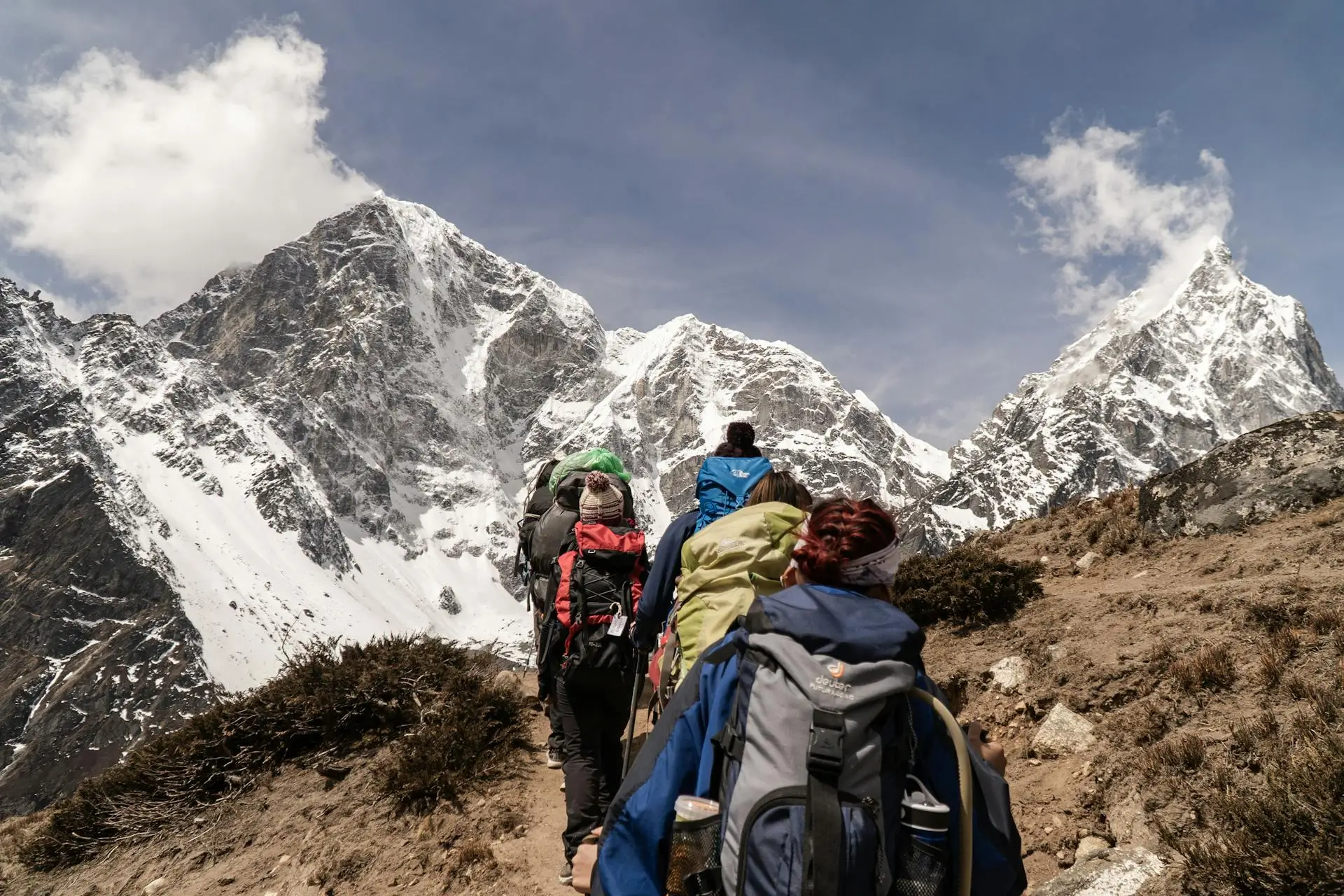 A group of trekkers on a snowy mountain path, emphasizing the safety of popular trekking trails in Nepal.
