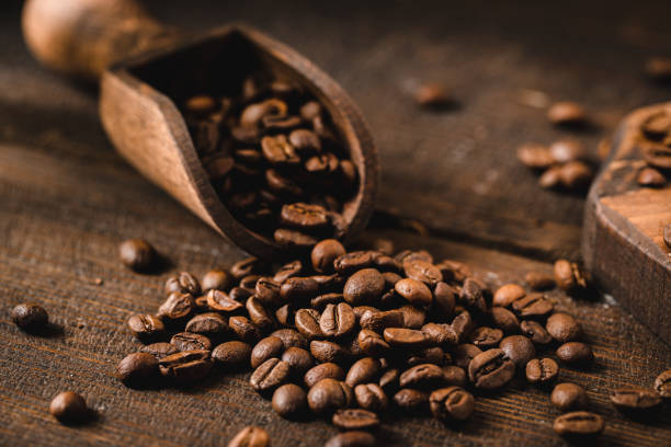A close-up of aromatic coffee beans on a wooden table.